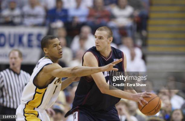 Jan Fikiel of the Pennsylvania Quakers looks to pass around Solomon Hughes of the California Golden Bears during the first round of the 2002 NCAA...