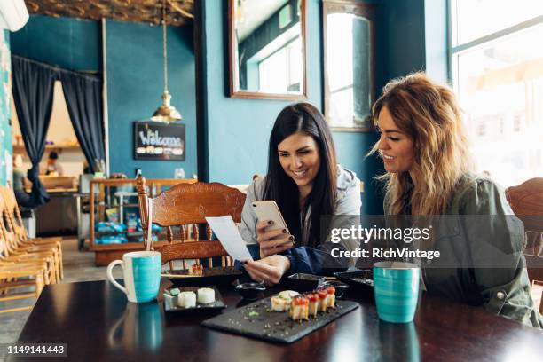 vrouw tracking restaurant bill - taking america to lunch stockfoto's en -beelden