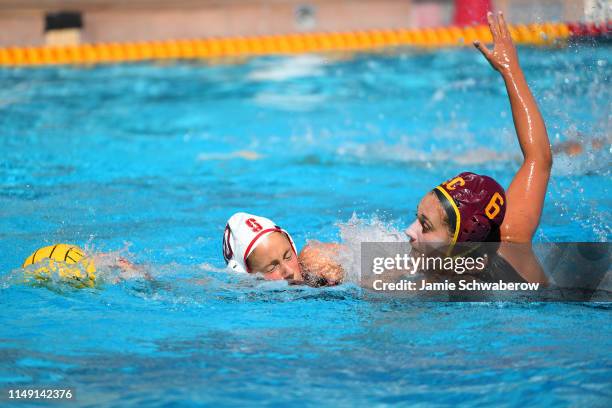 Bayley Weber of the USC Trojans and Kat Klass of the Stanford Cardinal battle for the ball during the Division I Women's Water Polo Championship held...