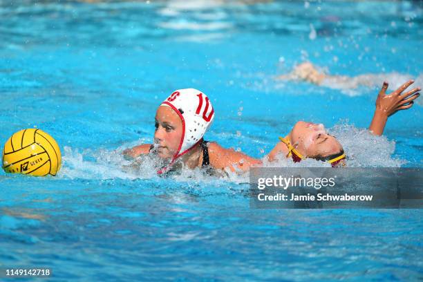 Bayley Weber of the USC Trojans and Kat Klass of the Stanford Cardinal battle for the ball during the Division I Women's Water Polo Championship held...