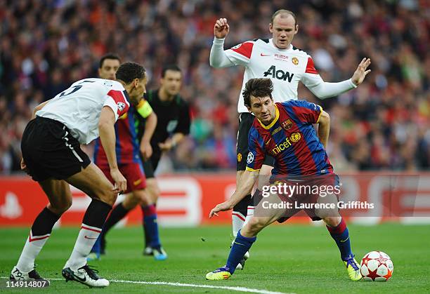 Lionel Messi of FC Barcelona in action against Rio Ferdinand and Wayne Rooney of Manchester United during the UEFA Champions League final between FC...