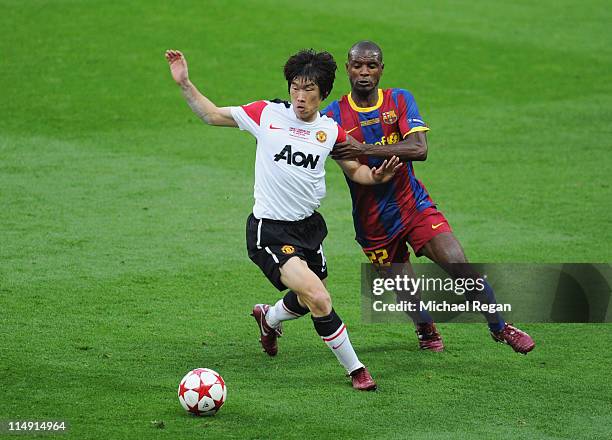 Park Ji-Sung of Manchester United is challenged by Eric Abidal of FC Barcelona during the UEFA Champions League final between FC Barcelona and...