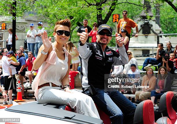 Alex Tagliani of Canada driver of the Sam Schmidt Motorsports Dallara Honda with his wife Bronte during the parade for the 100th Anniversary of the...