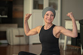 Senior woman with cancer flexing