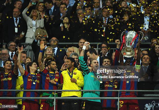 Eric Abidal of FC Barcelona lifts the trophy and celebrates with teammates after victory in the UEFA Champions League final between FC Barcelona and...