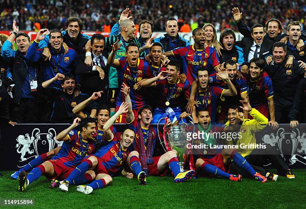 Lionel Messi and Daniel Alves of Barcelona hold the trophy as the team pose for photographs after victory in the UEFA Champions League final between...