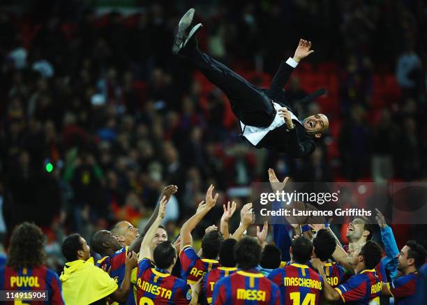 Josep Guardiola manager of FC Barcelona is thrown in the air as Barcelona celebrate victory in UEFA Champions League final between FC Barcelona and...