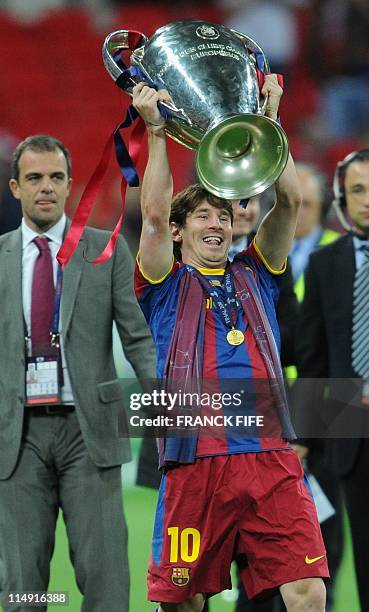 Barcelona's Argentinian forward Lionel Messi celebrates with the trophy at the end of the UEFA Champions League final football match FC Barcelona vs....
