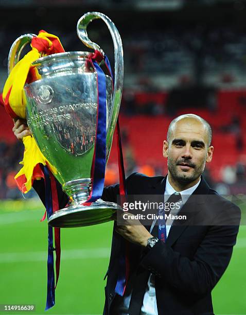 Josep Guardiola manager of FC Barcelona lifts the trophy after victory in the UEFA Champions League final between FC Barcelona and Manchester United...