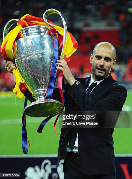 Josep Guardiola manager of FC Barcelona lifts the trophy after victory in the UEFA Champions League final between FC Barcelona and Manchester United...