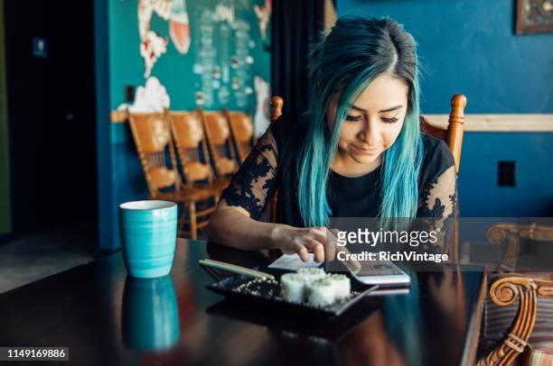 Hispanic Woman Checking Finances at Lunch