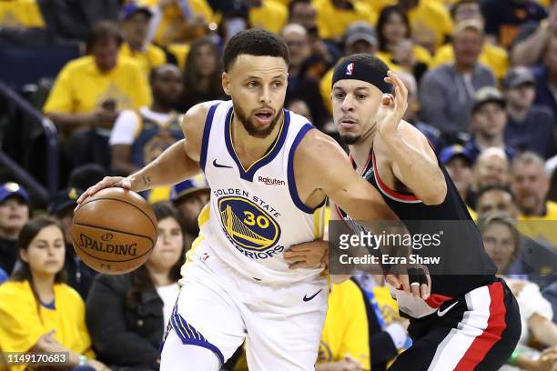 Seth Curry of the Portland Trail Blazers defends Stephen Curry of the Golden State Warriors during the first half in game one of the NBA Western...