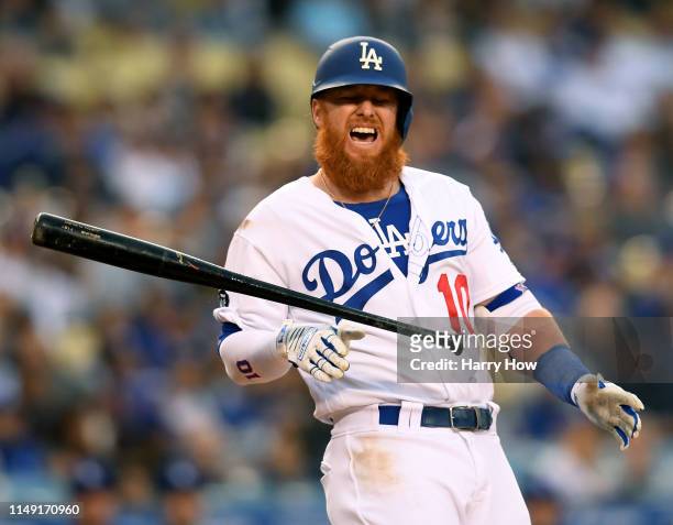Justin Turner of the Los Angeles Dodgers reacts after he is hit in the hands by a pitch from Chris Paddack of the San Diego Padres during the first...