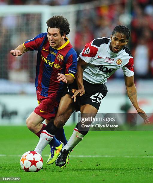 Lionel Messi of FC Barcelona clashes with Luis Antonio Valencia of Manchester United during the UEFA Champions League final between FC Barcelona and...