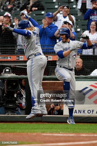 Vladimir Guerrero Jr. #27 of the Toronto Blue Jays celebrates with Randal Grichuk of the Toronto Blue Jays after hitting his first MLB home run...