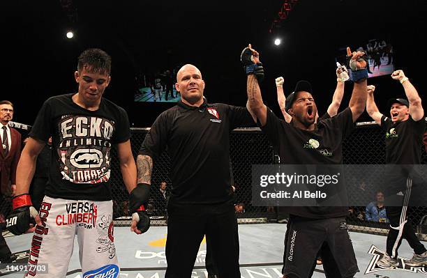 Demetrious Johnson celebrates his hard-fought victory over Miguel Torres during their bantamweight fight at UFC 130 at the MGM Grand Garden Arena on...