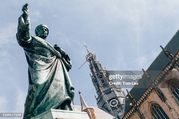 statue of laurens janszoon coster outside the grote kerk van st bavo, haarlem, netherlands - haarlem netherlands stock pictures, royalty-free photos & images