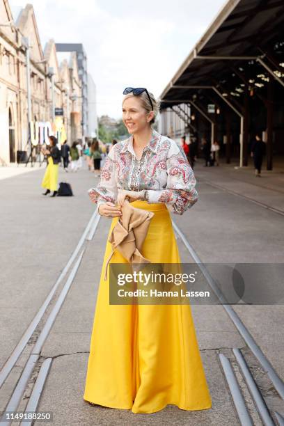 Kash Ohara wearing Yves Saint Laurent sunglasses, Zimmerman top, yellow wide pants at Mercedes-Benz Fashion Week Resort 20 Collections on May 15,...