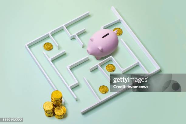 financial aspirational concept image. - piggy bank and maze stock pictures, royalty-free photos & images