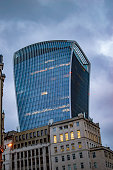 The walkie talkie building with cloudy sky and dark lights