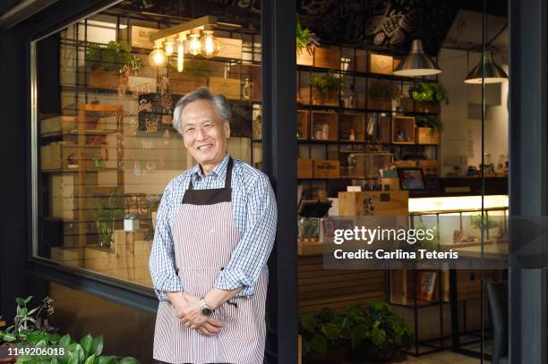 cafe owner standing outside of his shop - taipei business stock pictures, royalty-free photos & images