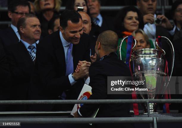 Prince Felipe of Spain shakes hands with Josep Guardiola manager of FC Barcelona after their victory during the UEFA Champions League final between...