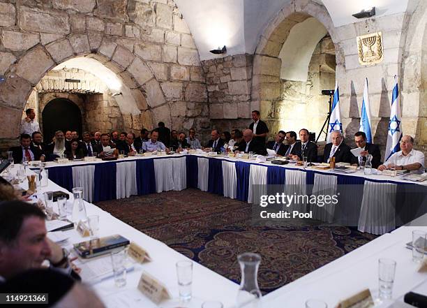 Israeli Prime Minister Benjamin Netanyahu sits next to Jerusalem Mayor Nir Barkat as he chairs the weekly cabinet meeting, the first since his return...