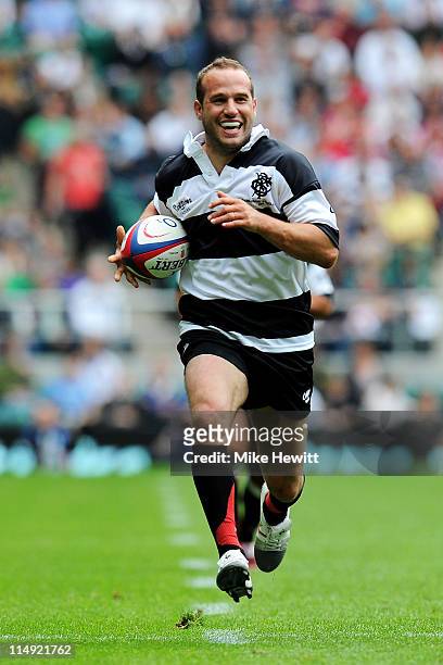 Frederic Michalak of Barbarians smiles as he makes a run to score a try during the match between England and Barbarians at Twickenham Stadium on May...