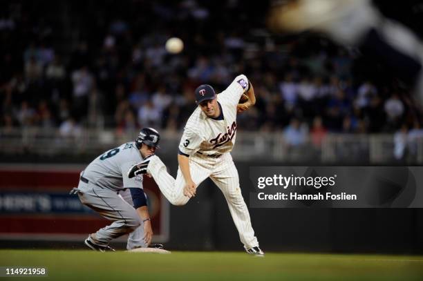 Jack Cust of the Seattle Mariners is forced out at second base as second baseman Michael Cuddyer of the Minnesota Twins tries to turn two during...