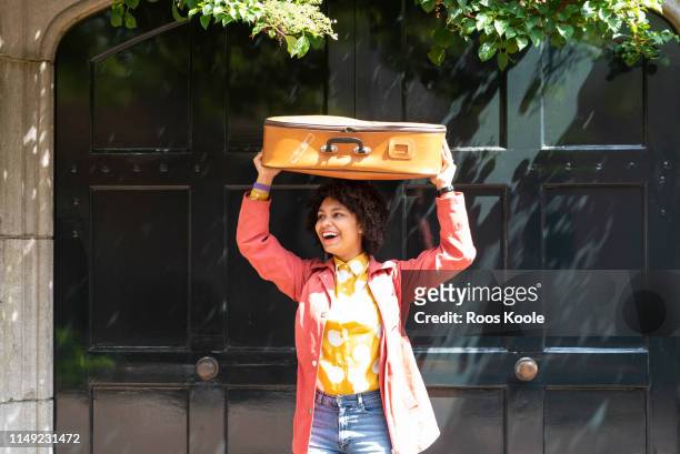 a young student with a suitcase - yellow suitcase stock pictures, royalty-free photos & images