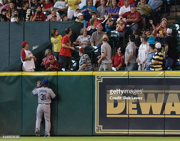 Right fielder Jay Gibbons of the Los Angeles Dodgers watches a ball hit by Michael Bourn of the Houston Astros leave the park for a home run in the...