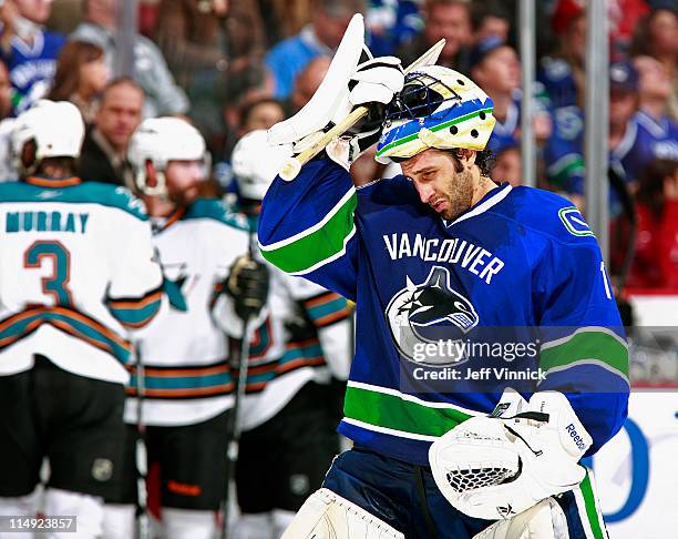 Roberto Luongo of the Vancouver Canucks adjusts his mask in Game Five of the Western Conference Finals during the 2011 NHL Stanley Cup Playoffs...