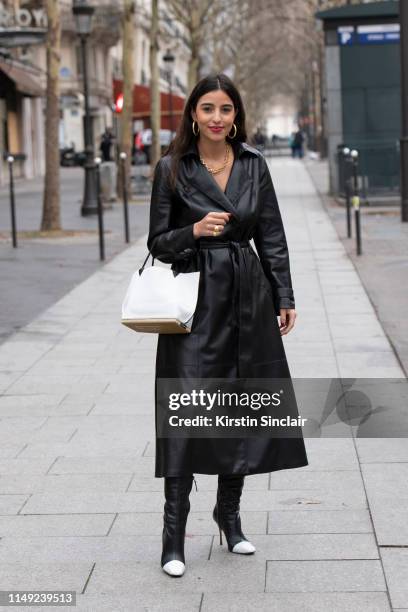 Personal shopper Bettina Looney wears a Nanushka trench, Altuzarra bag and Manolo Blahnik boots on March 02, 2019 in Paris, France.