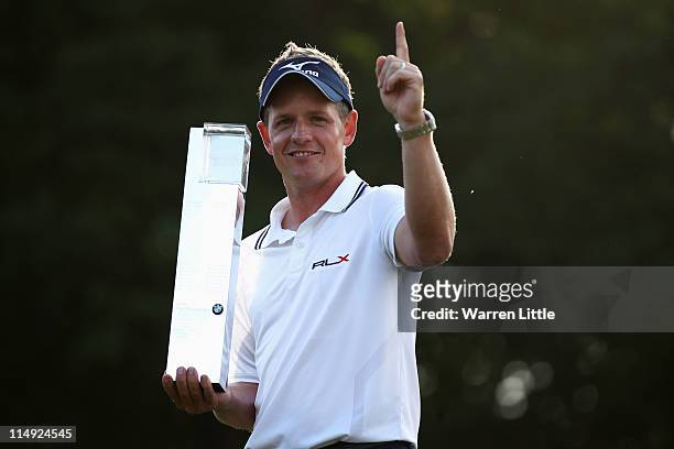 Luke Donald of England holds the trophy following his victory in a playoff on the 18th green, which also secured him the Number one World ranking...