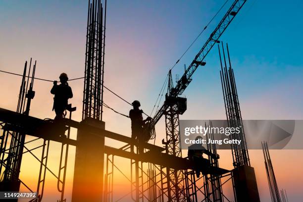 silhouette construction worker concrete pouring during commercial concreting floors of building in construction site and civil engineer inspection work - construction crane asia stock pictures, royalty-free photos & images