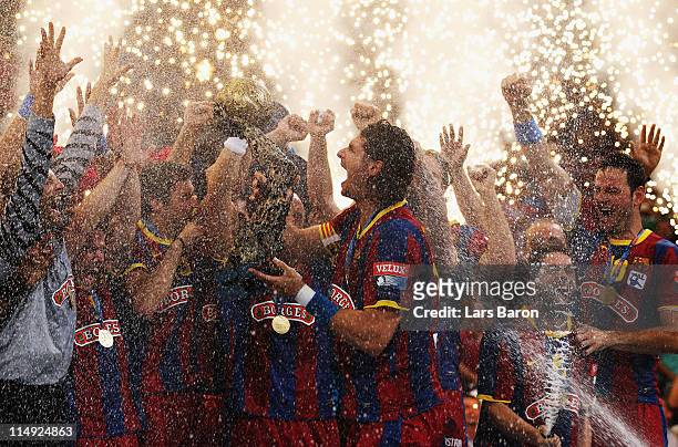 Captain Laszlo Nagy of Barcelona lifts the trophy after winning the EHF Final Four final match between FC Barcelona Borges and Ciudad Real at Lanxess...