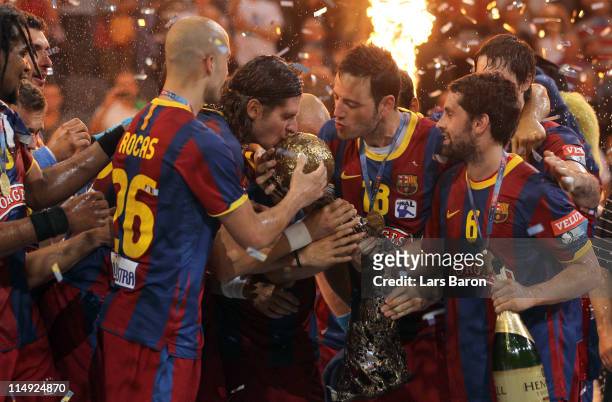 Captain Laszlo Nagy of Barcelona and team mate Iker Romero kiss the trophy after winning the EHF Final Four final match between FC Barcelona Borges...