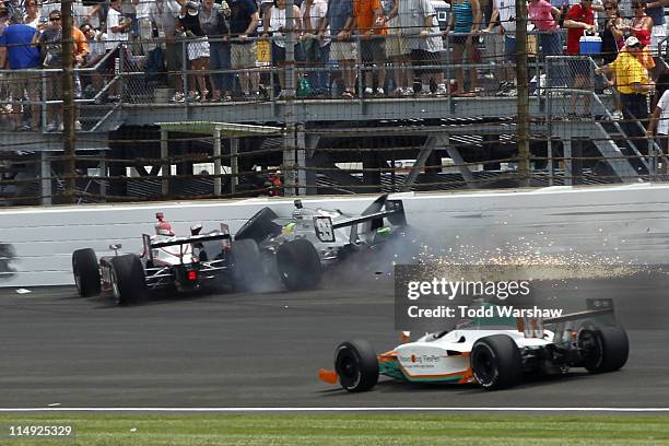 Ryan Briscoe, driver of the Izod Team Penske, and Townsend Bell , driver of the Herbalife Schmidt Pelfrey Racing, crash during the IZOD IndyCar...