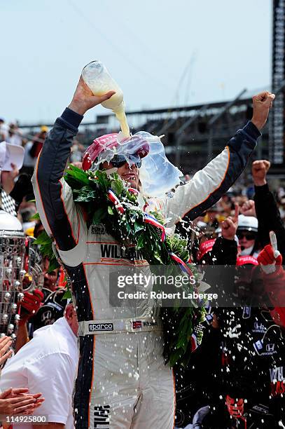 Dan Wheldon of England, driver of the William Rast-Curb/Big Machine Dallara Honda, celebrates in victory lane after winning the IZOD IndyCar Series...