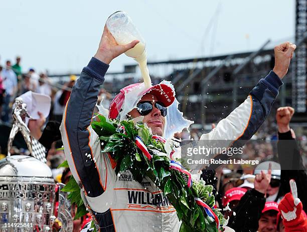 Dan Wheldon of England, driver of the William Rast-Curb/Big Machine Dallara Honda, celebrates in victory lane after winning the IZOD IndyCar Series...