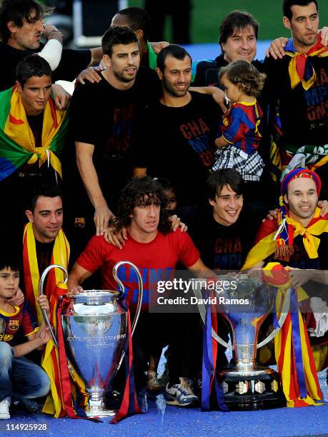 Barcelona players pose with the La Liga Tropy and the UEFA Champions League trophy during the celebrations after winning the UEFA Champions League...