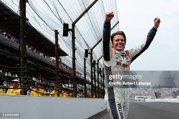 Dan Wheldon of England, driver of the William Rast-Curb/Big Machine Dallara Honda, celebrates at the start/finish line after winning the IZOD IndyCar...