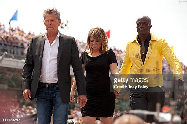 Global music superstars and Grammy Award winners David Foster, Kelly Clarkson and Seal walk onto the stage to perform the national anthem during the...