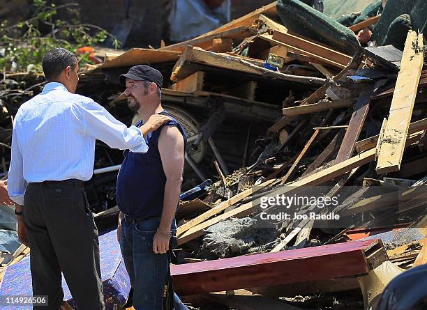 President Barack Obama greets a resident as he pays a visit to the community that was devastated a week ago by a tornado on May 29, 2011 in Joplin,...