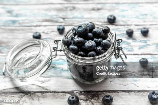 fresh blueberries in a glass - blaubeeren stock pictures, royalty-free photos & images