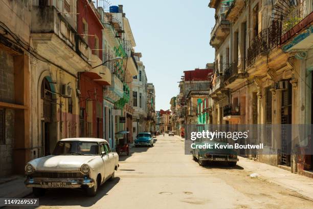 multiple classic cars parked on the street in central havana - cuba stockfoto's en -beelden