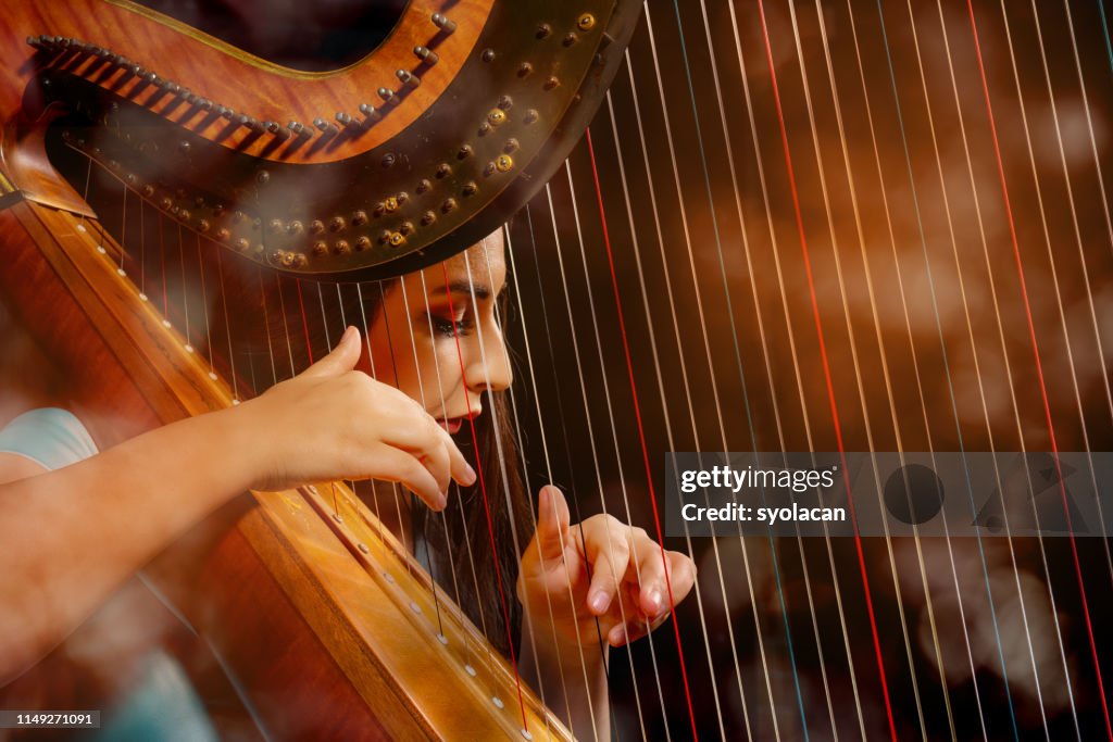 Professional female harpist during performance