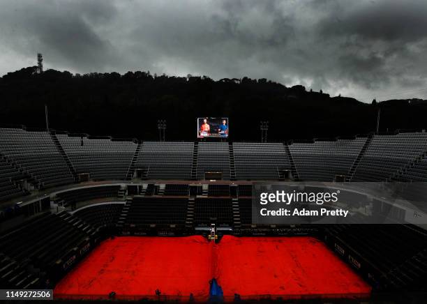 General view of a wet centre court with Roger Federer of Switzerland due to play Joao Sousa of Portugal delayed by rain during day four of the...