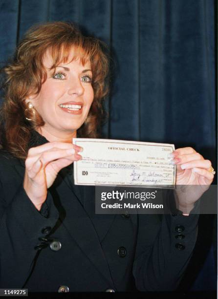 Paula Jones holds a check for one millian dollars given her by Abe Hirschfeld at the Mayflower Hotel in Washington, D.C. October 31, 1998. New York...