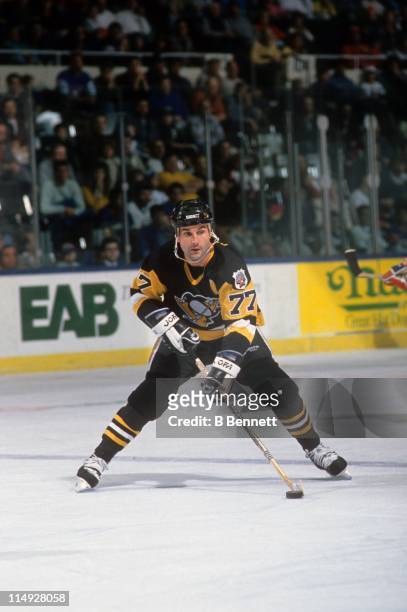 Paul Coffey of the Pittsburgh Penguins skates with the puck during an NHL game against the New York Islanders circa 1992 at the Nassau Coliseum in...